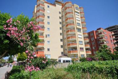 Alanya property balcony with tile flooring, metal railing, and bright, sunny views of the neighborhood.