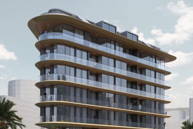 L'espace de vie moderne de cette propriété d'Alanya comprend un coin repas, une cuisine élégante et un canapé confortable éclairé par un éclairage circulaire et chaleureux.
