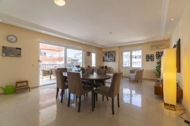 Bright, airy apartment featuring an open-plan living and dining area with balcony access and city views.