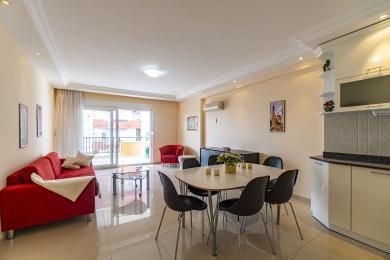 Bright apartment featuring an open living and dining area with access to a balcony, ideal for relaxed city living.