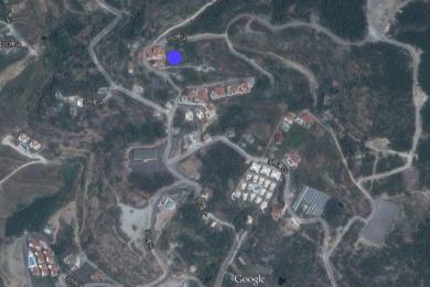 Aerial view of a landscape with buildings, roads, and vegetation.